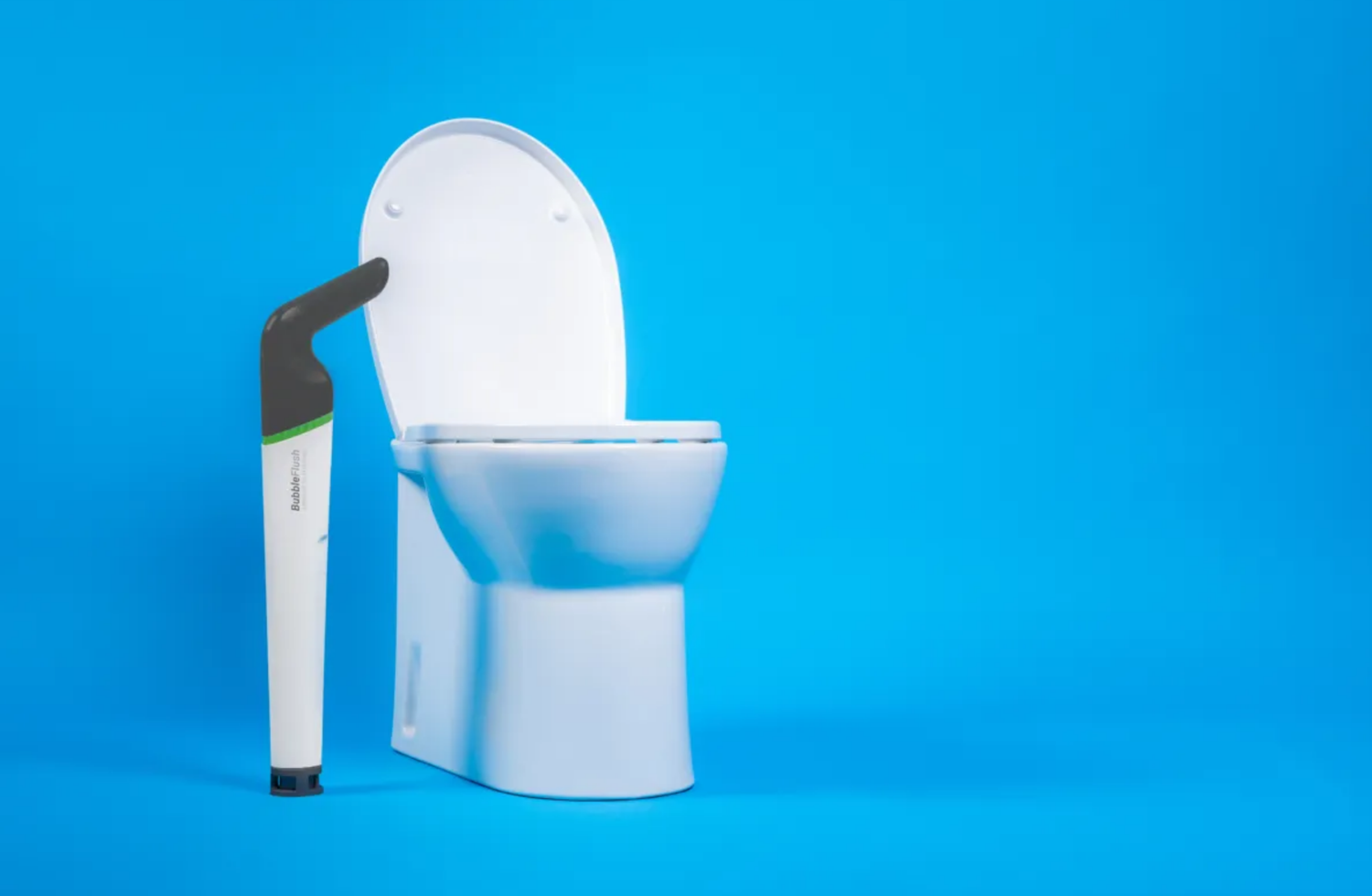 White toilet with a black and green cleaning brush on a blue background