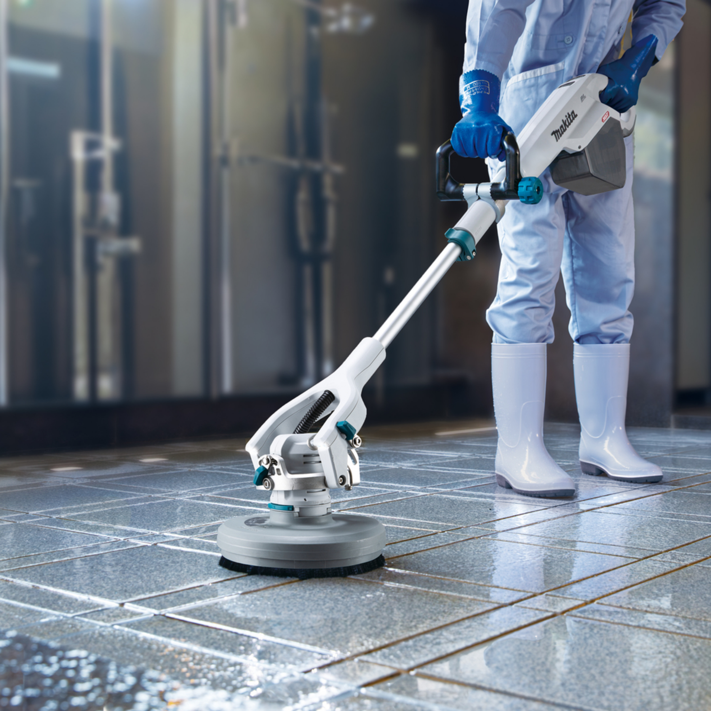 Person using a floor polisher on a tiled floor